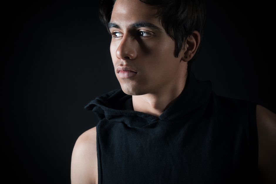 Low-key studio portrait of a man in black