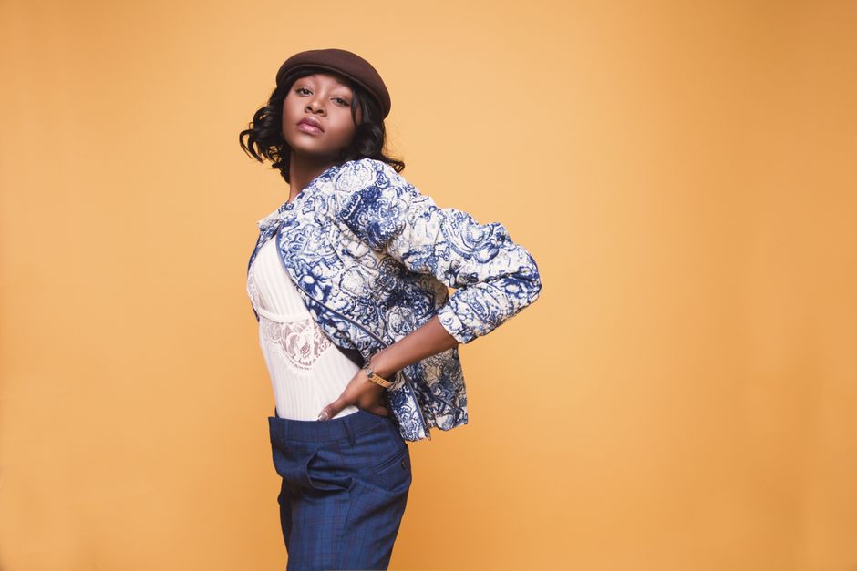 Editorial fashion portrait against a warm backdrop