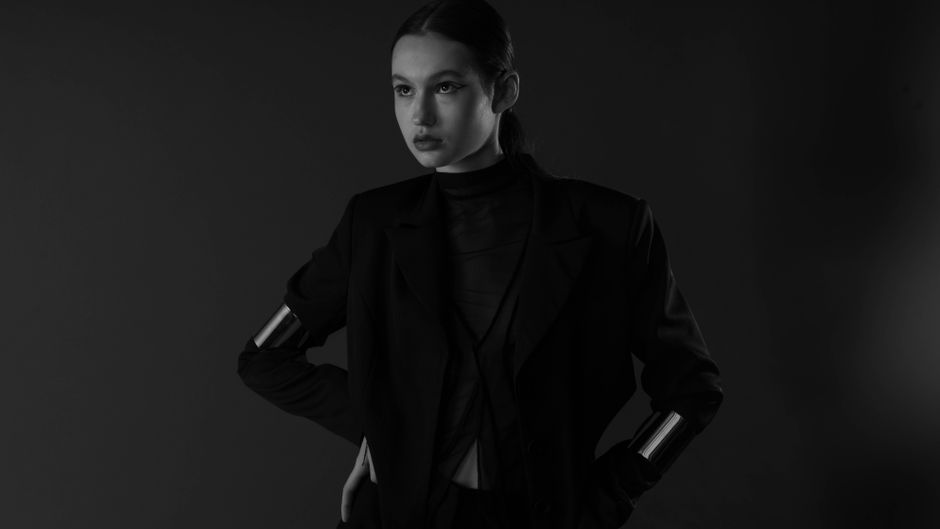 Black and white editorial portrait in a tailored jacket